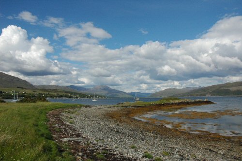 The view looking along the length of Loch Carron with the village hugging the shore line and the unmistakable outline of "Wellington" in the background.